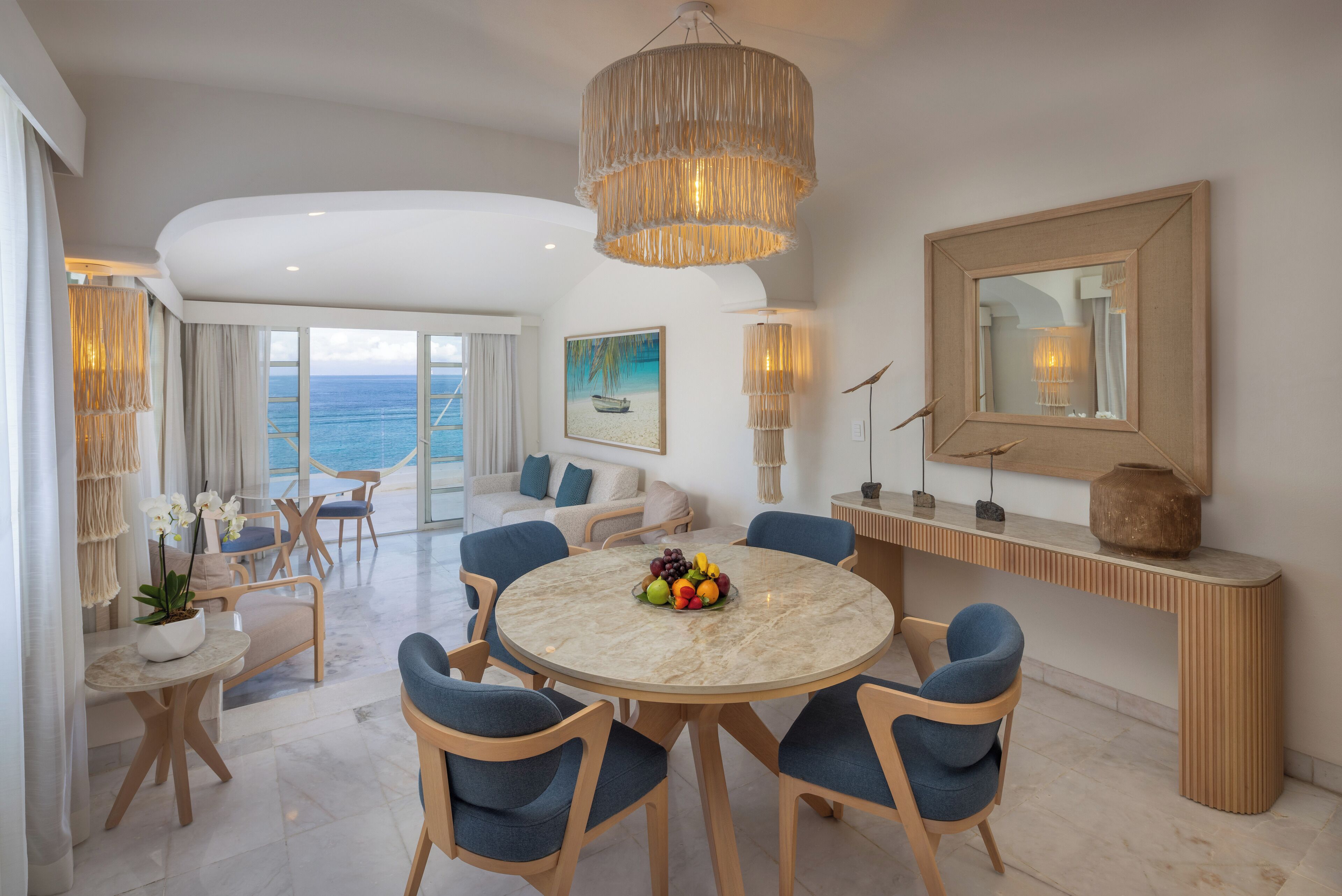 Ocean-view living and dining area inside a Cozumel Palace suite
