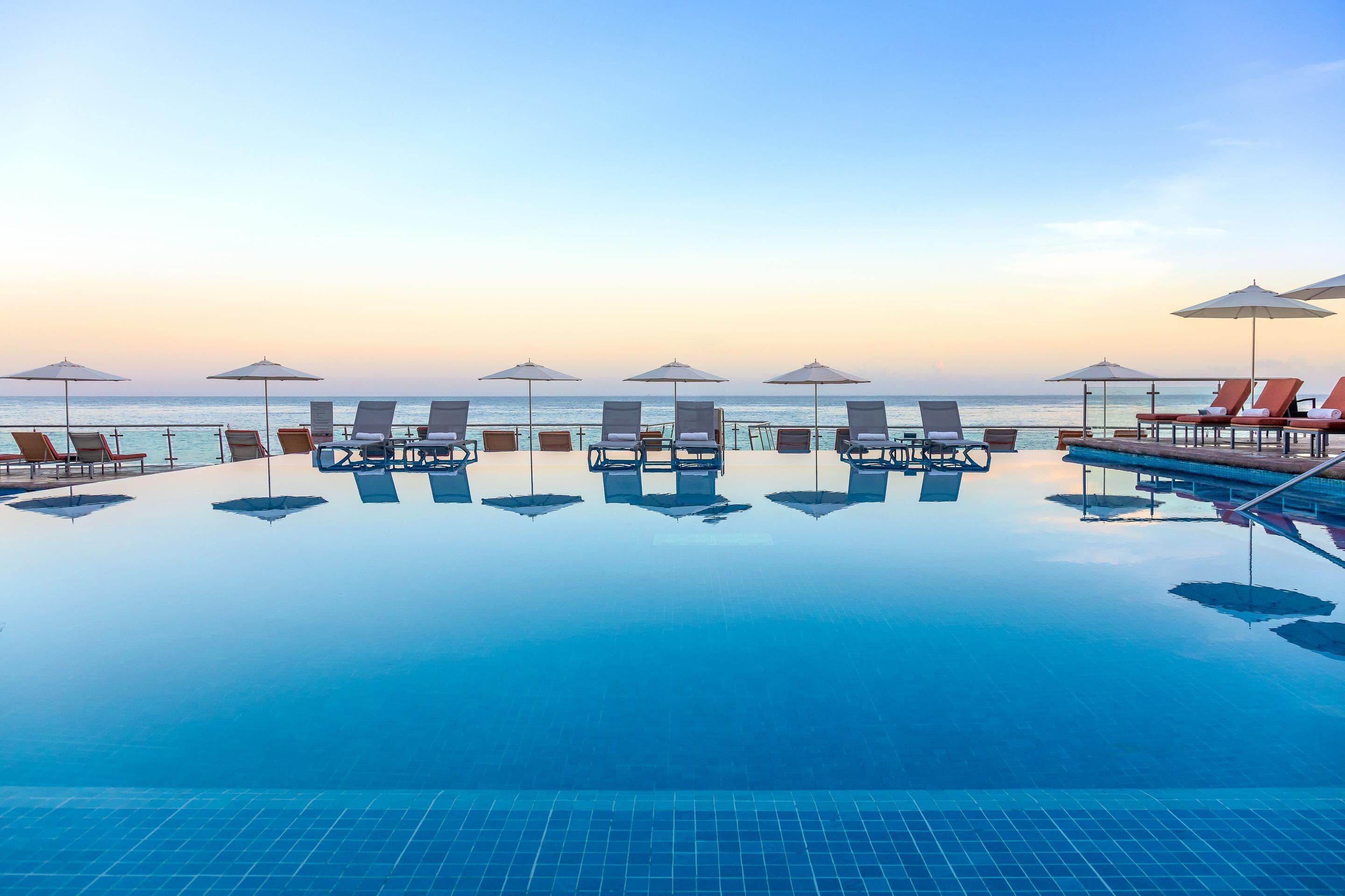 Ocean-view pool and loungers at Cozumel Palace